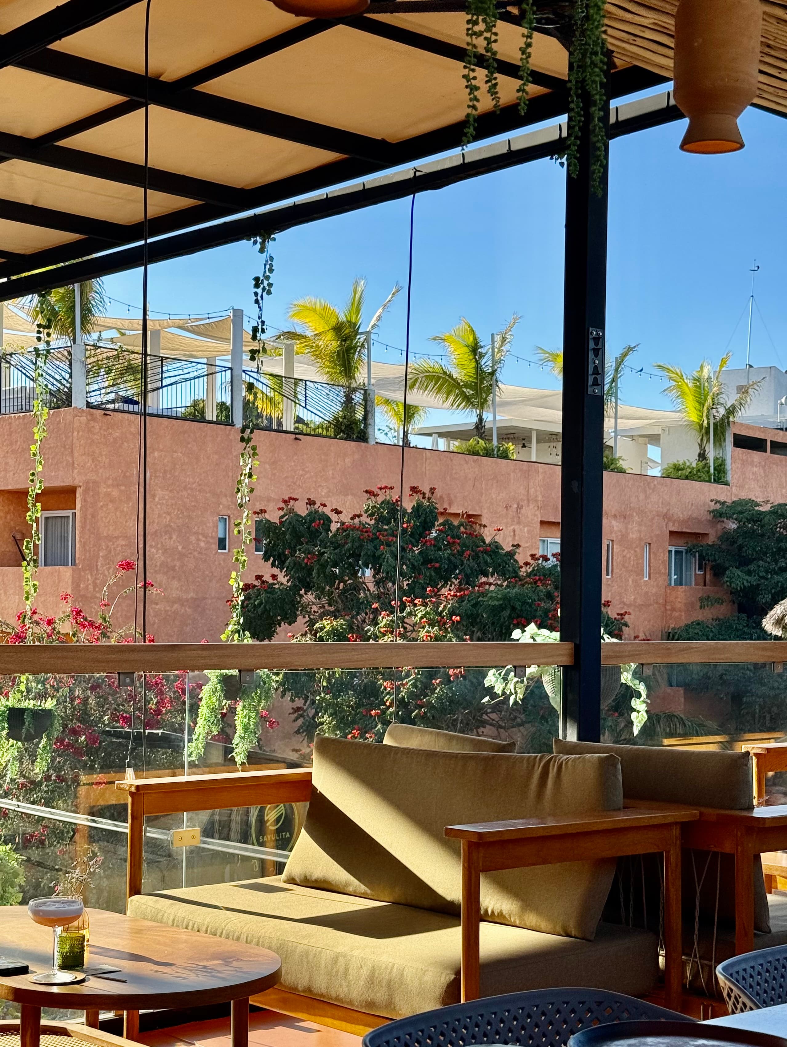Inspiration — golden-hour rooftop lounge with tropical greenery